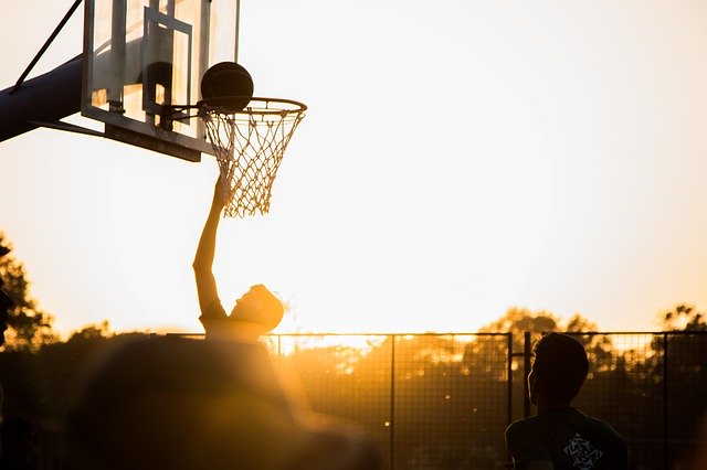 High impact basketball dunk, showing high impact.