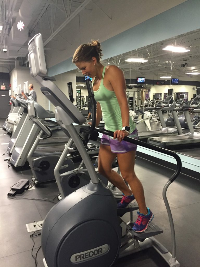 A woman using an elliptical, another form of the best low impact exercise.