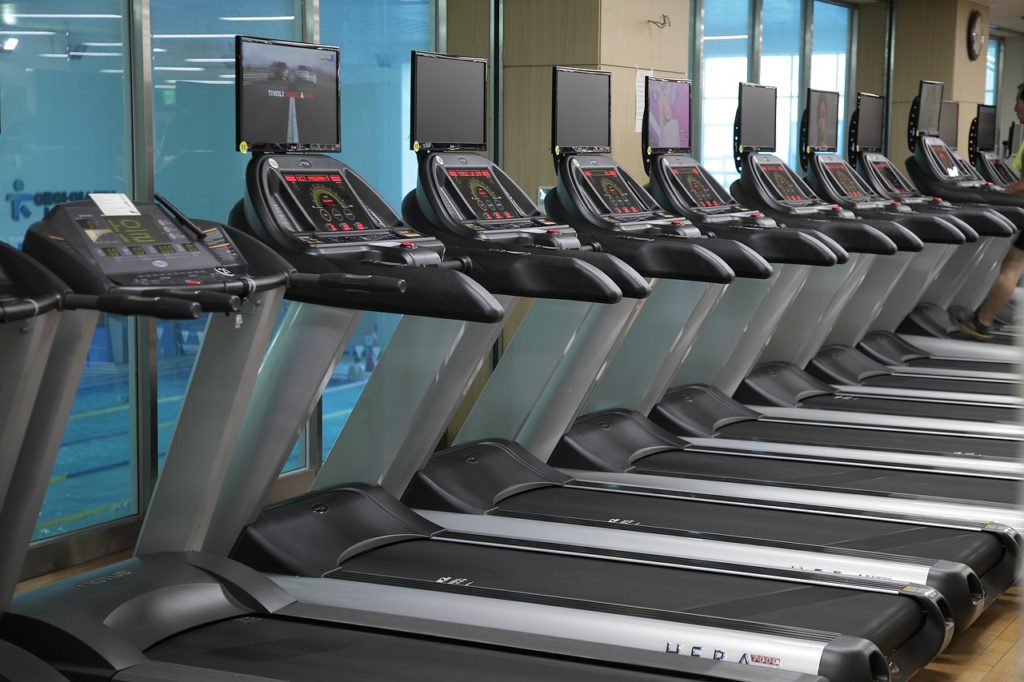 Image of multiple treadmills, a form of low impact exercise equipment.